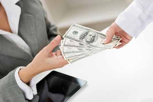 A client hands money to an investment adviser